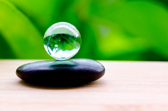 Marbles on top of zen stone symbolizing enlightenment and positive energy, with customizable space for text.