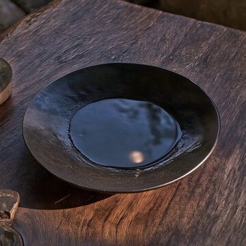 Centered top-down Chengni inkstone composition, semi-dry black ink reflecting bright moon, unground ink stick with subtle gold light, deep wood grain table, low saturation warm palette, meditative sti