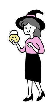Woman in witch costume with pumpkin basket in hand
