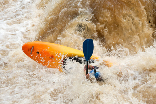 Orange kayak whitewater rescue paddle river rapid