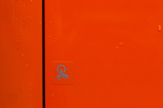 Orange metal panel with blue touch symbol and water droplet texture creating vivid technology background