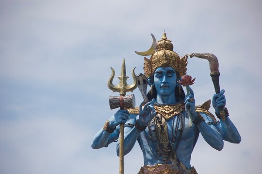 Blue Statue of Shiva Holding Trident and Lotus