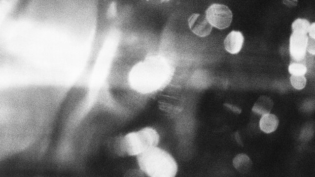 Blurred city lights at night with bokeh effect creating abstract urban ambiance