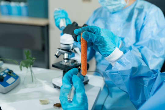 Team scientists research natural skincare products in a modern laboratory, testing formulas, analyzing ingredients, and driving cosmetic innovation and development.