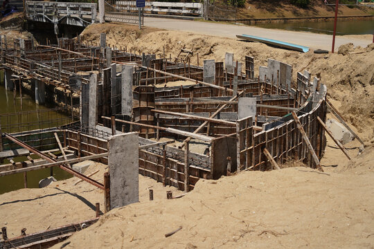 Building process city levee. Exposed foundation rebar grid at site, standing formwork and concrete footings