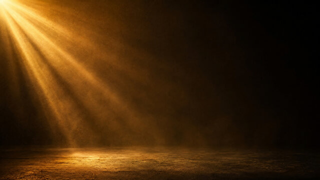 Cinematic golden spotlight on dark background, dramatic light rays over empty stage floor, warm sunbeam effect for product presentation