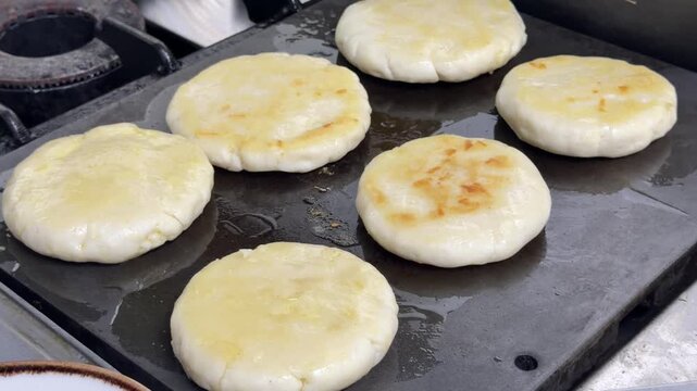 Traditional korean hotteok cooking on a hot griddle