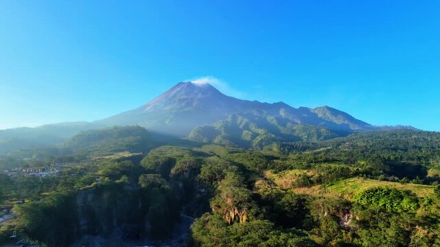 Aerial drone zoom out to merapi volcano landscape for travel documentary