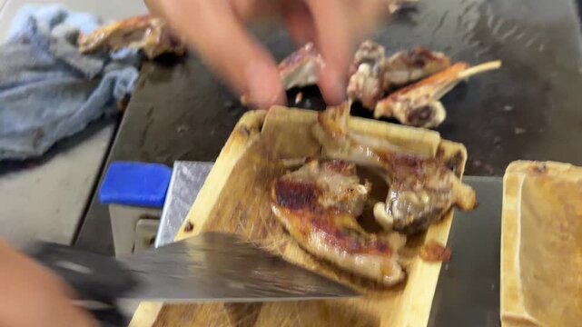 Chef grilling and serving lamb chops in a restaurant kitchen