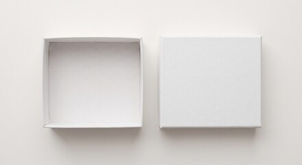 Fototapeta premium View of an open white gift box with a separate lid placed side by side on a neutral background
