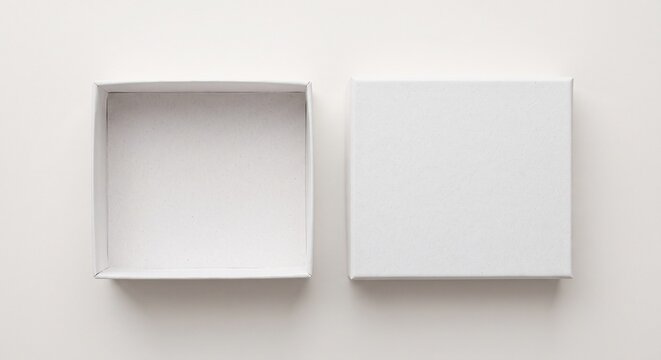 View of an open white gift box with a separate lid placed side by side on a neutral background