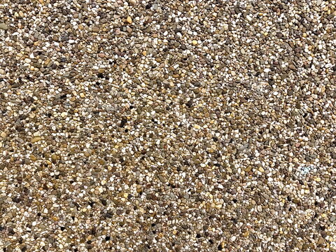Small pebble stone gravel texture background, mosaic stone pavement closeup.