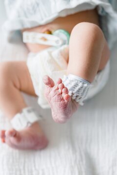Wrinkled foot of a newborn baby with hospital id band