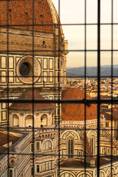 View of Florence Cathedral dome through a metal grate