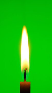 Single Lit Candle Flame Flickering Gently On Bright Green Screen Background, Isolated Fiery Candlelight And Glowing Wick For Chroma Key, Meditation, Peace And Spiritual Design.