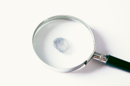 Magnifying glass on a white background with a fingerprint in it