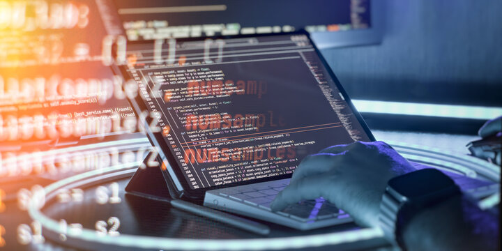 Software developer working on machine learning algorithm and business metrics in modern neon workspace.