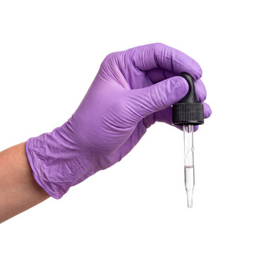 Squeezing rubber dropper pipette in hand isolated on a transparent or black background. Pharmacist liquid drug formulation and clinical chemical drops measurement, medical laboratory.