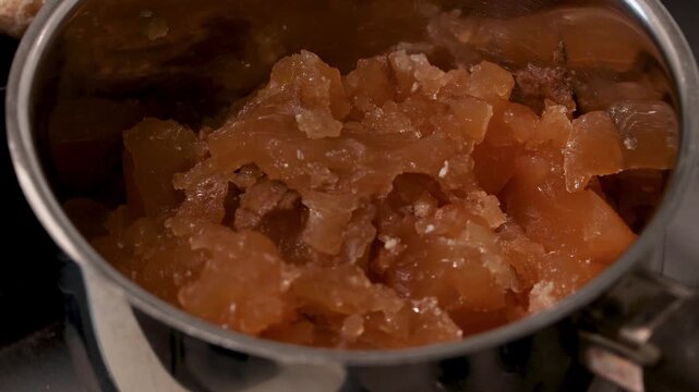 Dense, gelatinous bone broth cooled and tested with a spoon for collagen-rich texture