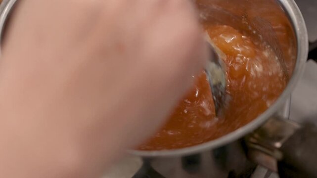 Dense gelatinous bone broth on stovetop highlights collagen-rich texture for health