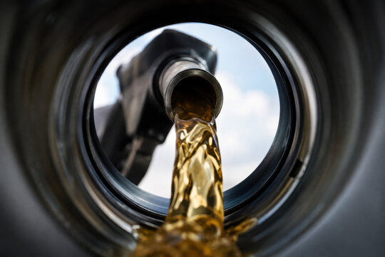 View of  Gasoline Fuel Flowing from Nozzle into Car Tank