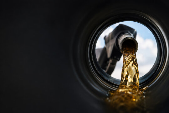 View of  Gasoline Fuel Flowing from Nozzle into Car Tank