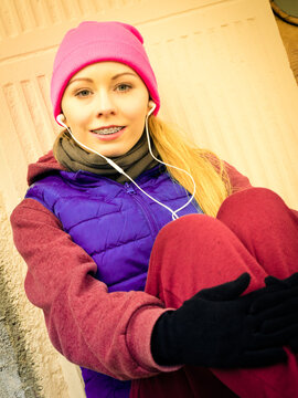 Woman wearing warm sportswear relaxing after exercising