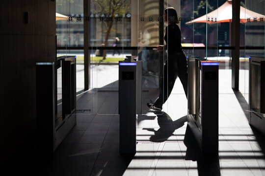 Person Walking Through Building Security Turnstile