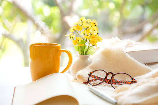 Notebook with life goals for personal growth and future planning with yellow cup coffee in warm sunshine.  Goal Life Wellness Concept.