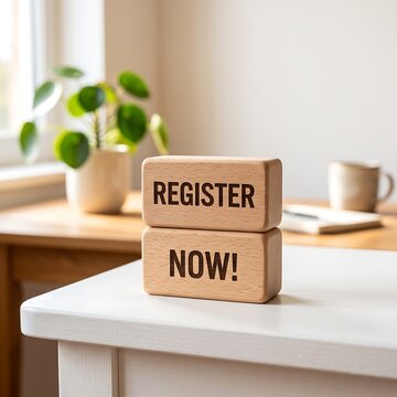 Register now text on wooden blocks on a desk