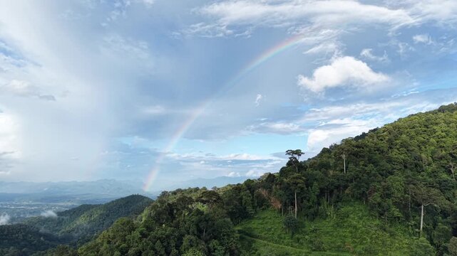 Aerial view from drone of the rainbow over the forest and mountain
