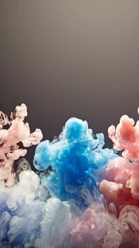 Abstract Motion of Blue and Pink Ink Clouds Swirling in Water on Dark Background