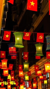 chinese lanterns hanging in street at night with flag