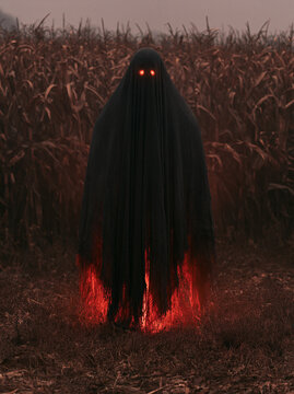 Creepy black shadow entity with glowing red eyes standing in a dark autumn cornfield at dusk for Halloween horror