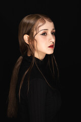 Moody profile portrait of young woman with dramatic makeup on black background © VuXuan