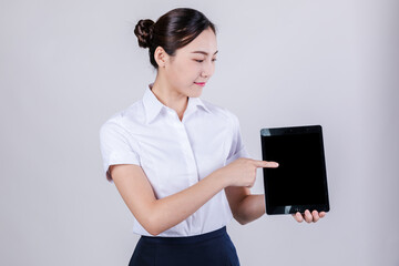 Professional woman holding tablet and pointing at blank screen © TrinhAnhBao