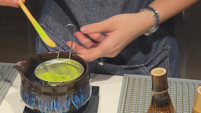Sifting Matcha Powder Through Fine Mesh Strainer for Tea Preparation