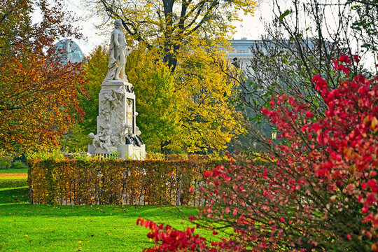 The historic Mozart Monument in the Burggarten palace garden surrounded by vivid autumn foliage, Vienna