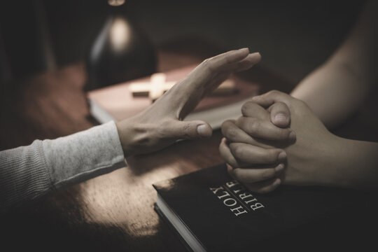 Christian prayer between two people holding hands, seeking God&rsquo;s blessing, guidance, peace, and comfort through faith.