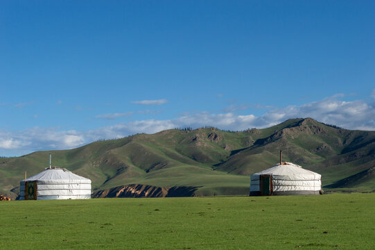 Two gers beneath distant hills at dawn, Orkhon Valley, Mongolia