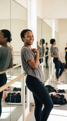 Fototapeta premium A woman laughs while leaning on a ballet barre. She enjoys the process of movement without judgment. Ideal for wellness, hobby, or mental health content.