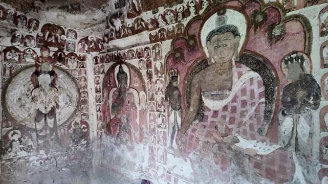 Saspol, India : Panoramic footage of Buddhist wall paintings dating from 13th to 15th centuries located in Saspol cave, famous ancient Buddhist temple in the cliff of Saspol village of Ladakh, India