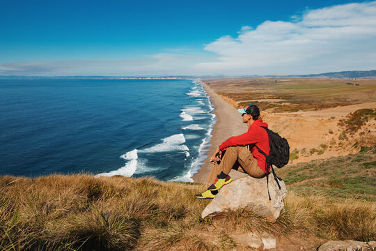 Travel in Point Reyes National Seashore, man Hiker with backpack enjoying view, California, USA