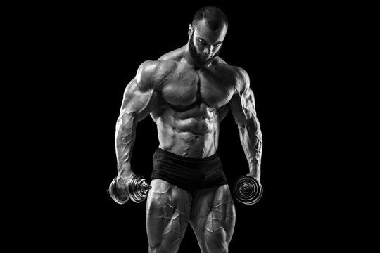 Bodybuilder man on the black background. Strong male naked torso abs