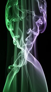 Abstract Green and Purple Smoke Swirls Rising on Black Background
