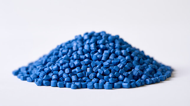 A pile of vibrant blue plastic polymer pellets on a clean white background, showcasing raw material for industrial manufacturing and pro