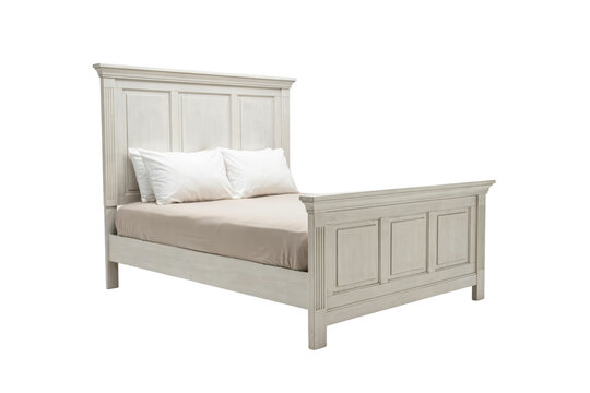 White wooden bed frame with paneled headboard and footboard featuring two white pillows and beige bedding isolated on a transparent background