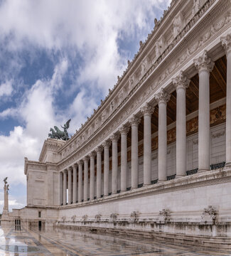 A view of Rome at sun. A monument in Rome with beautiful clouds and a quadriga. Venice Square in Rome.