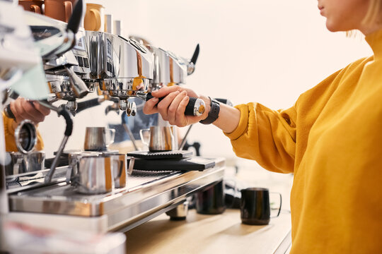 Barista making coffee with coffee machine