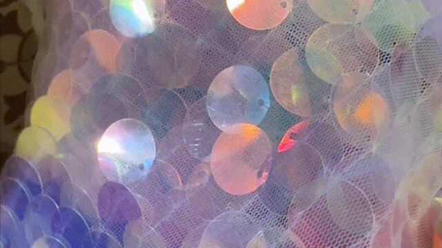 Sequined fabric shimmering under stage lighting. Concept of fashion, glamour, luxury, performance and creativity. High quality 4k footage